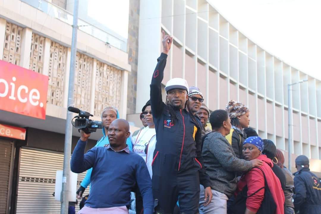 Tebogo Obusitse in foreground wearing white cap at last week's massive community march.